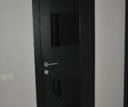Black door in a bright room