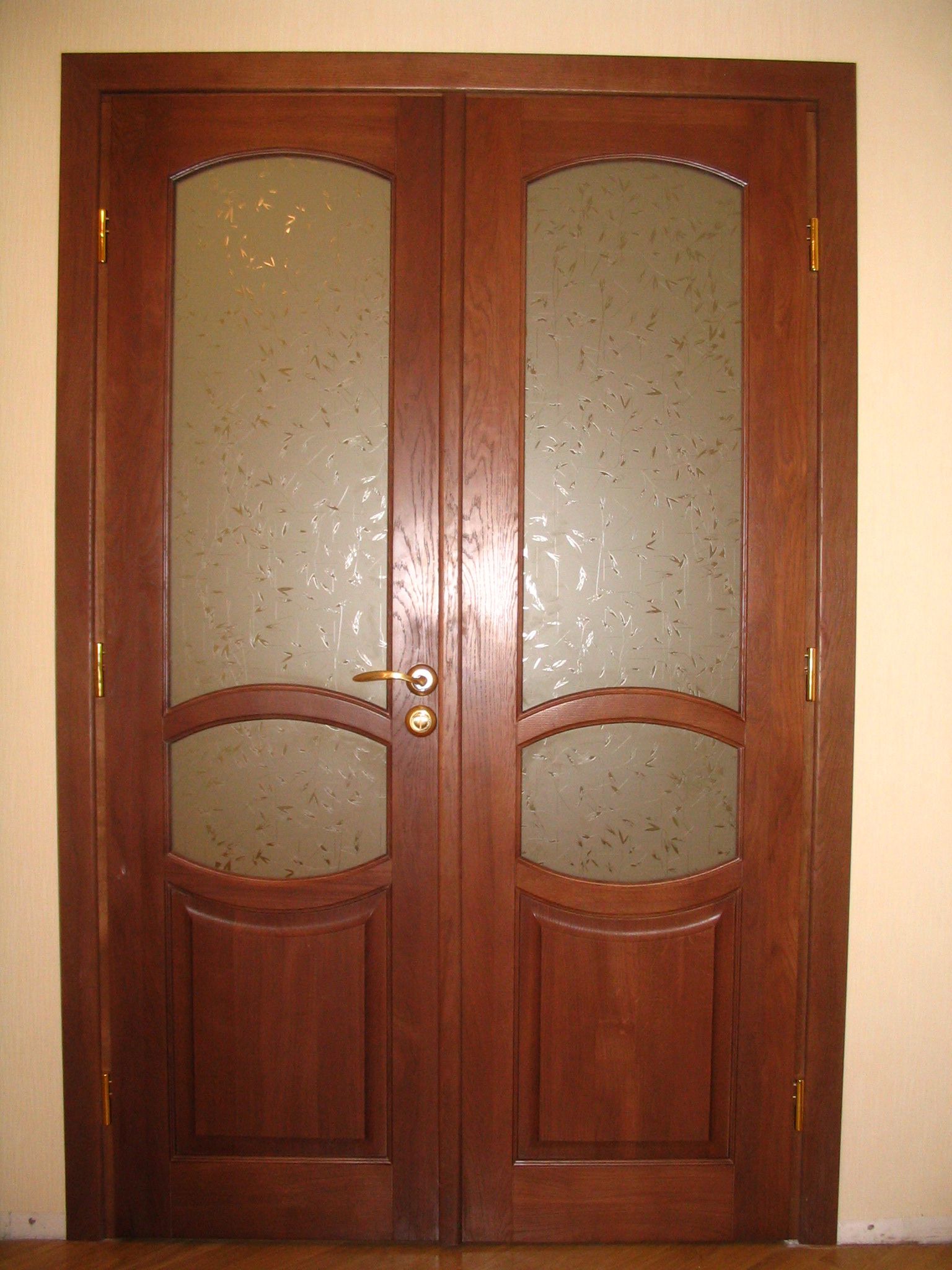 Dark brown masonite two-leaf door with glass