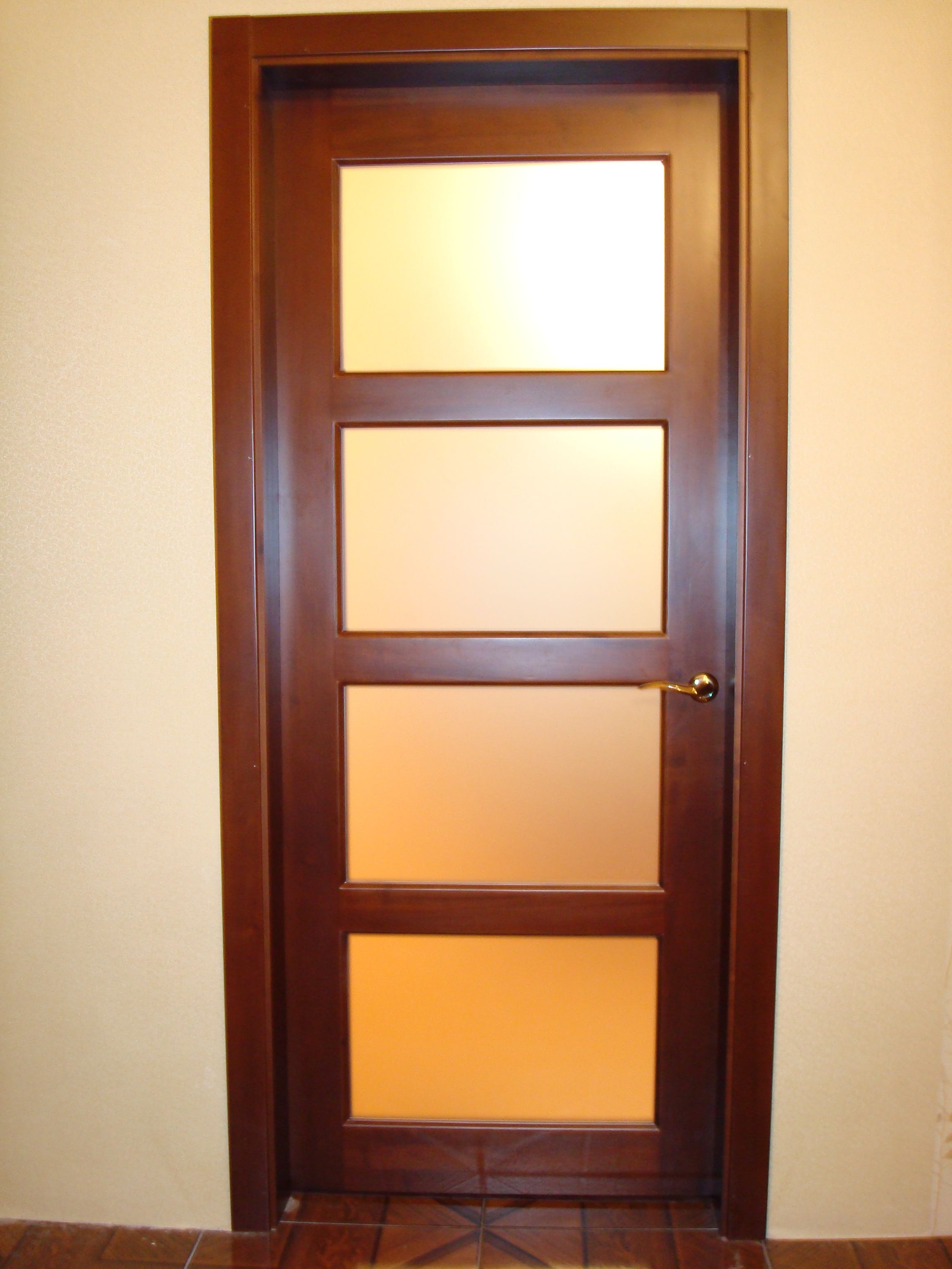 Modern brown wooden door with glass in bright room