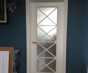 White wooden interior doors with white door frame