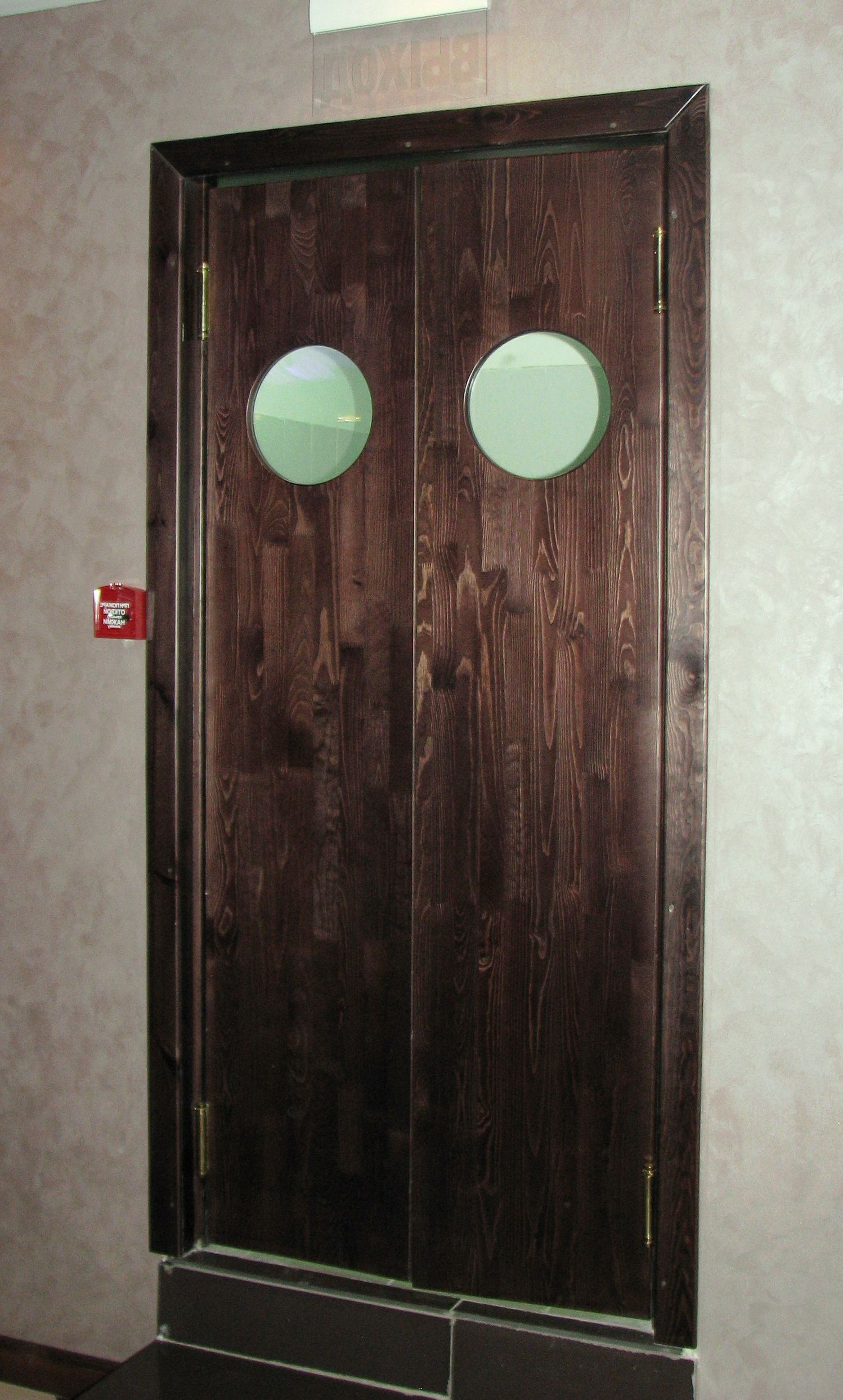 Swing door made of natural wood covered with stain