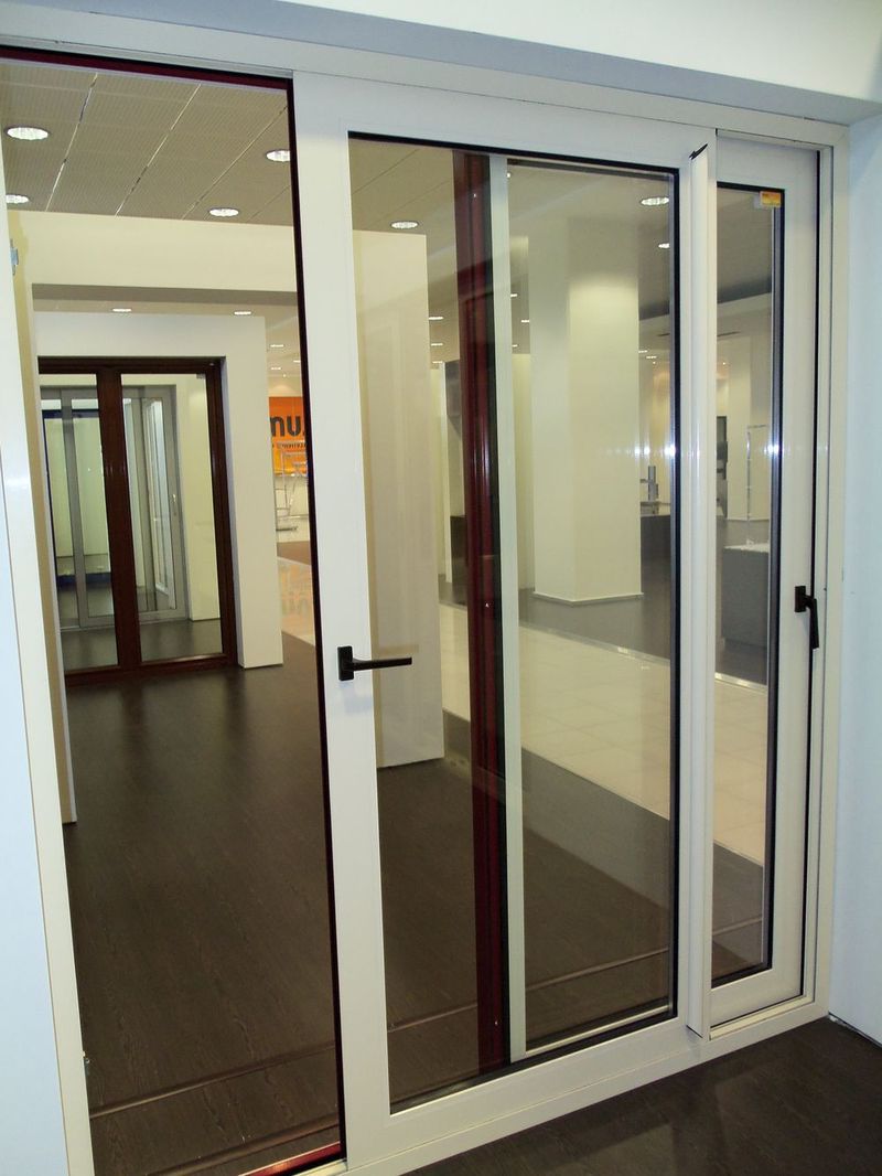 White interior sliding aluminium doors with glass