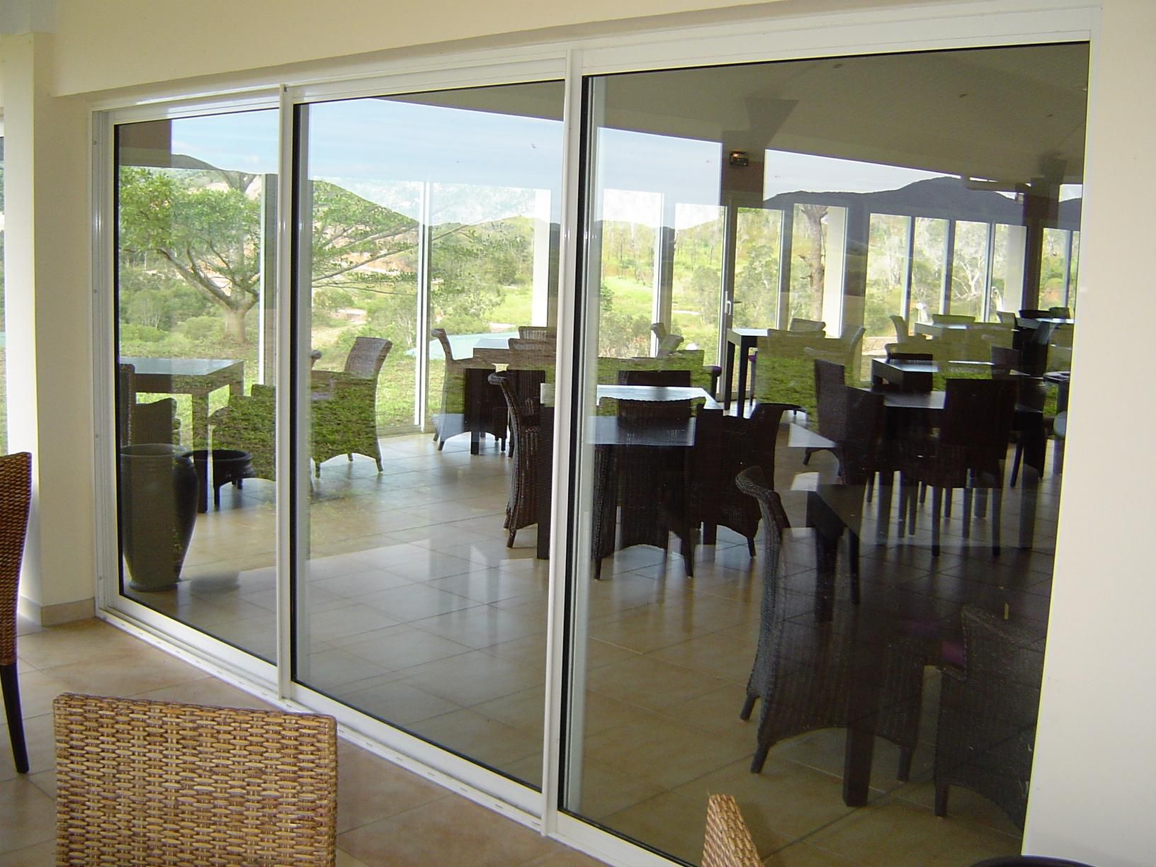 White sliding aluminum door with a large glass for the dining room in the hotel