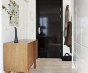 Black interior door with white walls and light floor