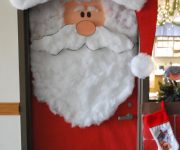 Decorating doors for the New Year in the form of Santa Claus