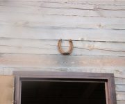 Horseshoe over the front door of a wooden house