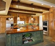 Built-in spotlights and chandelier in the interior design of the country style kitchen