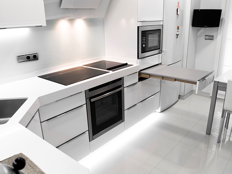 Household appliances in a white kitchen in high-tech style – Microwave, stove, oven, TV