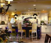 The idea of kitchen country style in yellow tones, with Wallpaper on the walls