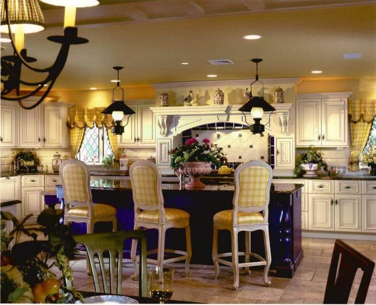 The idea of kitchen country style in yellow tones, with Wallpaper on the walls