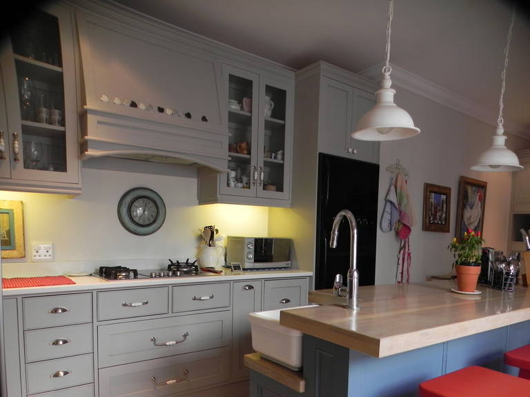 White pendant lamp, Gray cabinets, countertop with sink in the kitchen in country style